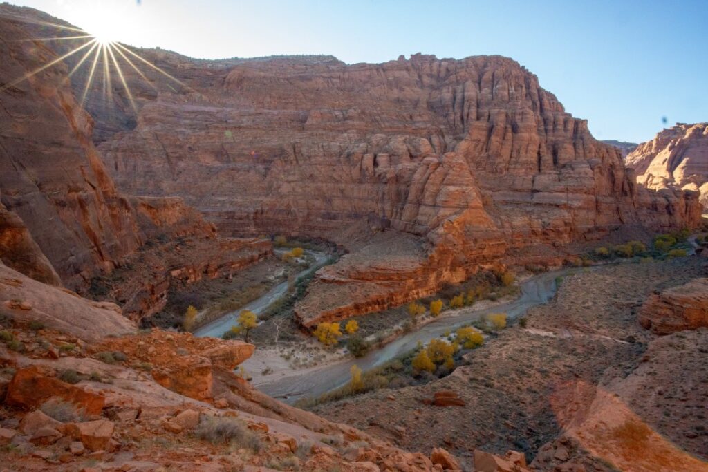 An image from the rim of a desert canyon looking down into it.